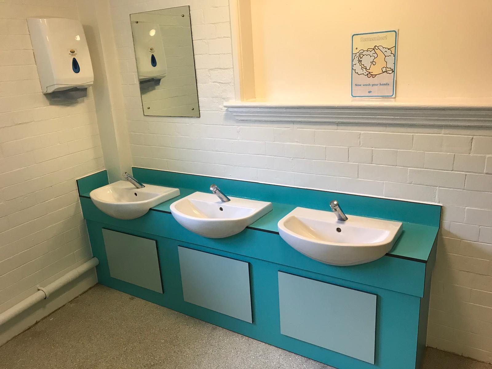 Refurbished school washroom with new vanity unit and three basins